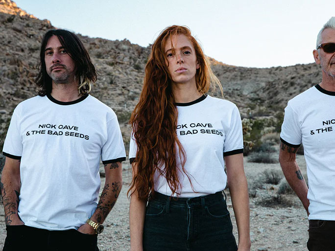 Classic Ringer Tee with the band Nick Cave and The Bad Seeds Text Logo Print photographed in the desert