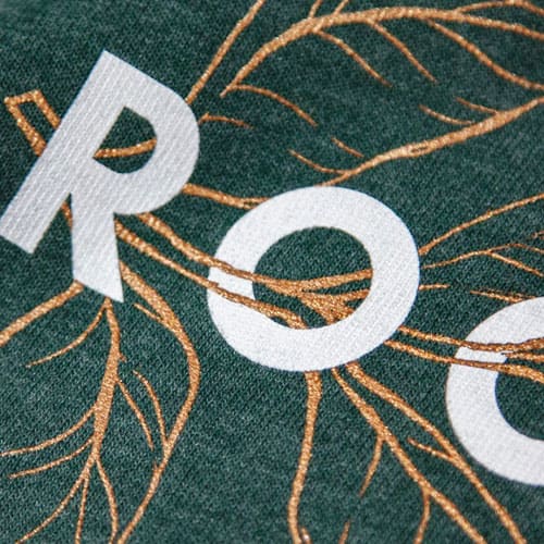 Screen Printing Close Up on Pine Green AS Colour Staple Tee with a Metallic Gold and White Plastisol Ink Print