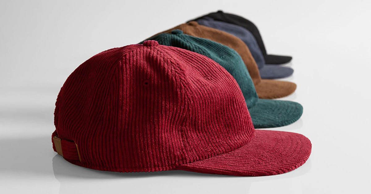 a row of corduroy caps in a range of different colours