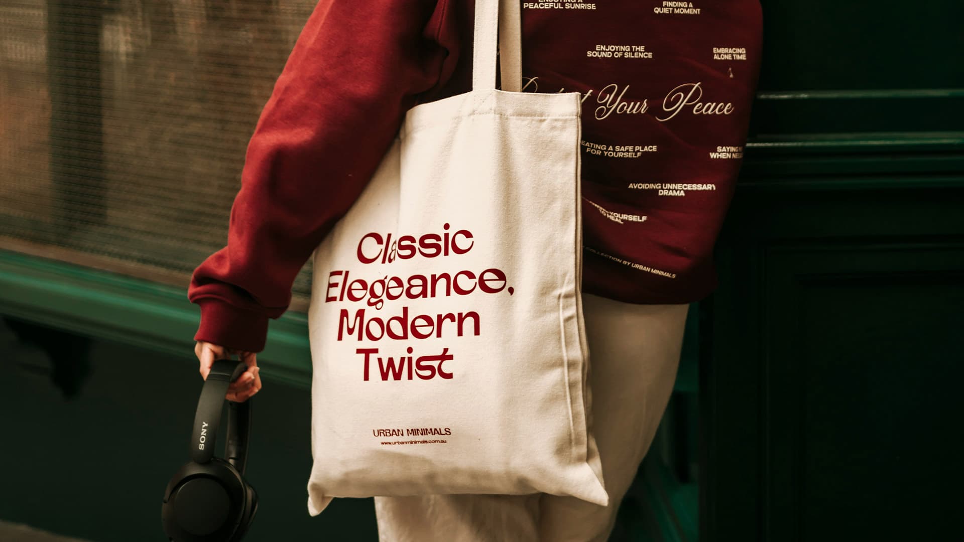 A high-quality cotton tote bag customised with a bold modern text logo, photographed in natural light in Melbourne, highlighting the sustainable material.