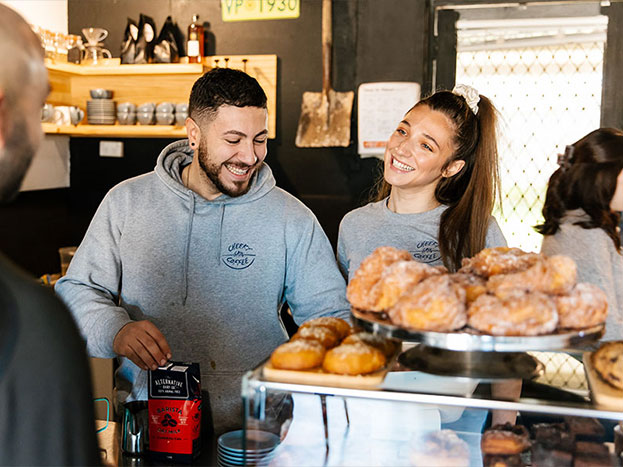 Custom screen printed hoodies and staff tees for Cheeky Grin Coffee in Adelaide