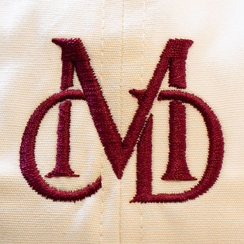 custom embroidery close up with burgundy thread MD logo