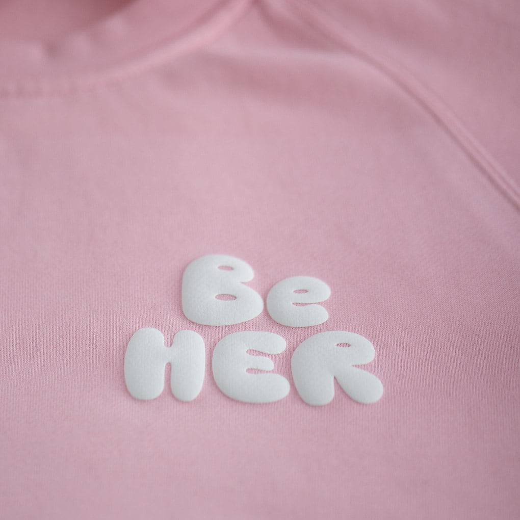 Custom Puff Print with the word "Be Her" on a Pink Jumper