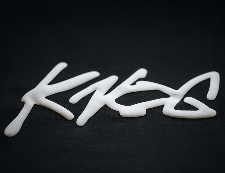 White Puff Print with the Knog Logo on a Black AS Colour Heavy Tee