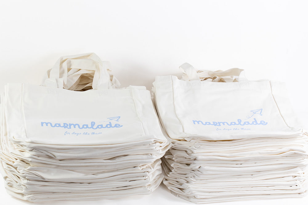 custom-screen-printed-tote-bags Custom screen printed tote bags with Marmalade print in pale blue plastisol ink