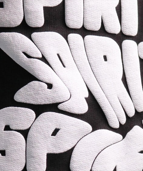 Puff Print in White Ink Close Up View on a Black T-Shirt