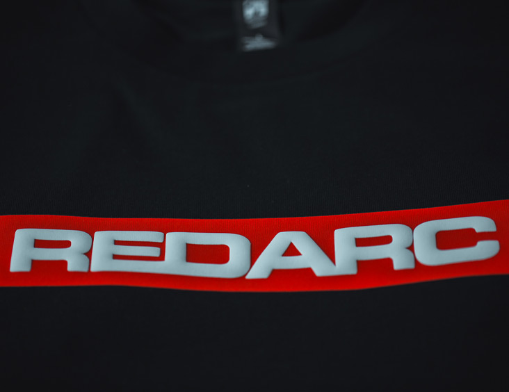 Puff Printed Custom T-Shirt Logo Design for REDARC with a flat red DTF Print underneath with a White Puff ink printed on the top